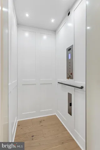 a bedroom with a large bed and a potted plant