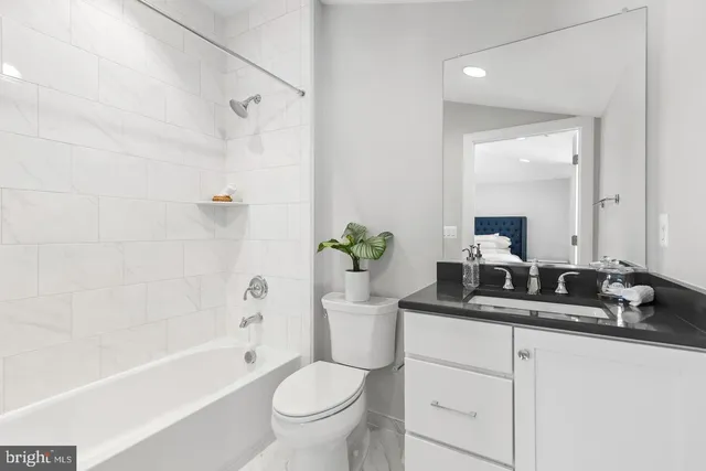 a bathroom with a sink a toilet and a bathtub