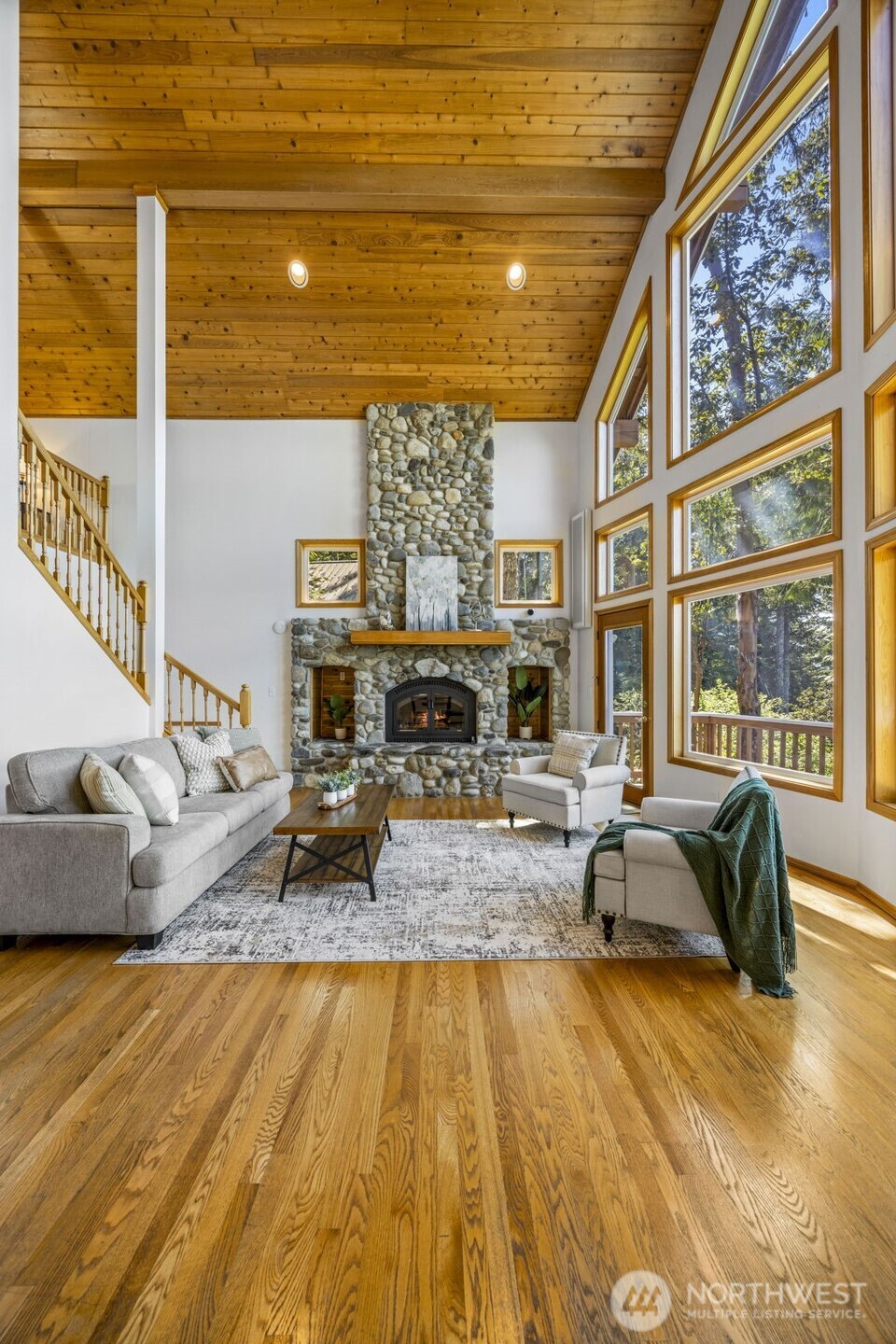 19736 Northwest Stavis Bay Road Seabeck, WA 98380 - Photo 17 of 39 a living room with fireplace furniture and a large window