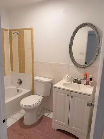 a bathroom with a sink toilet and a mirror