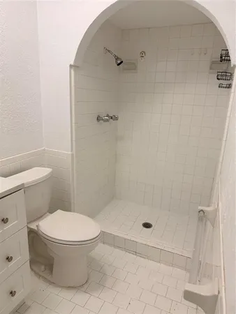 a bathroom with a toilet a sink and a mirror