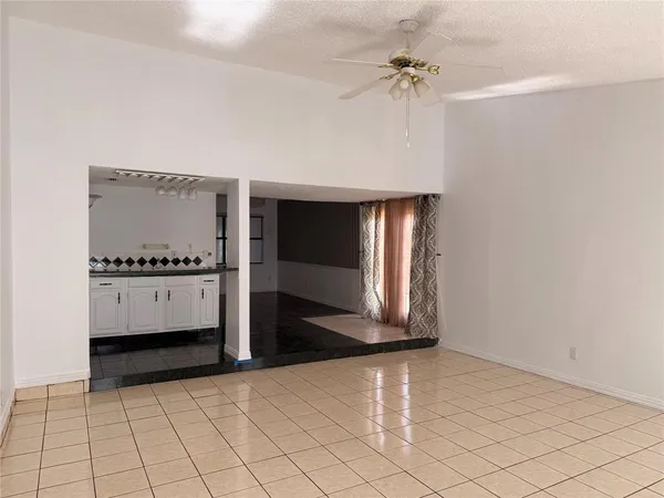 a view of a kitchen with white cabinets and sink