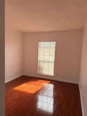 a view of a backyard with a large tree