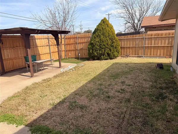 a view of a house with backyard and a barbeque