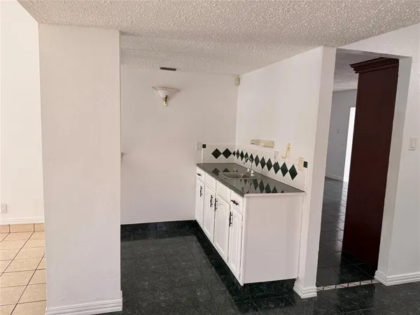 a kitchen with a sink and a stove