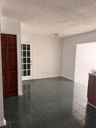 a kitchen with a stove sink and cabinets