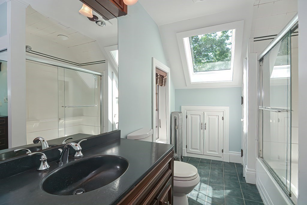 1 Summit Road Franklin, MA 02038 - Photo 26 of 42 a bathroom with a granite countertop sink a toilet a mirror and shower