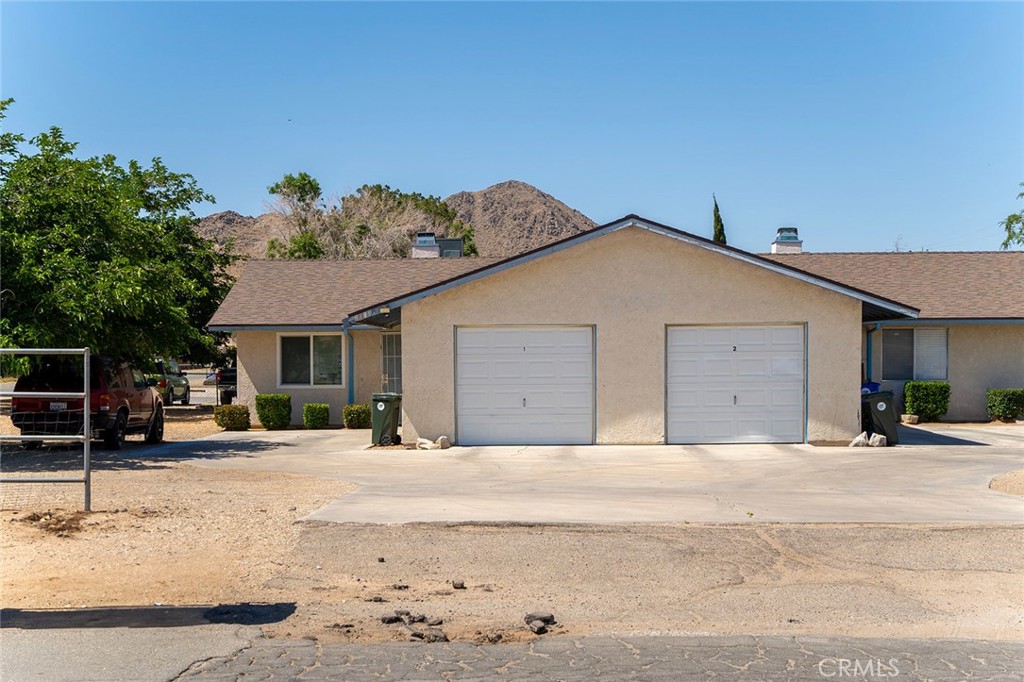 20120 Serrano Road Apple Valley, CA 92307 - Photo 1 of 1 a front view of a house with a yard