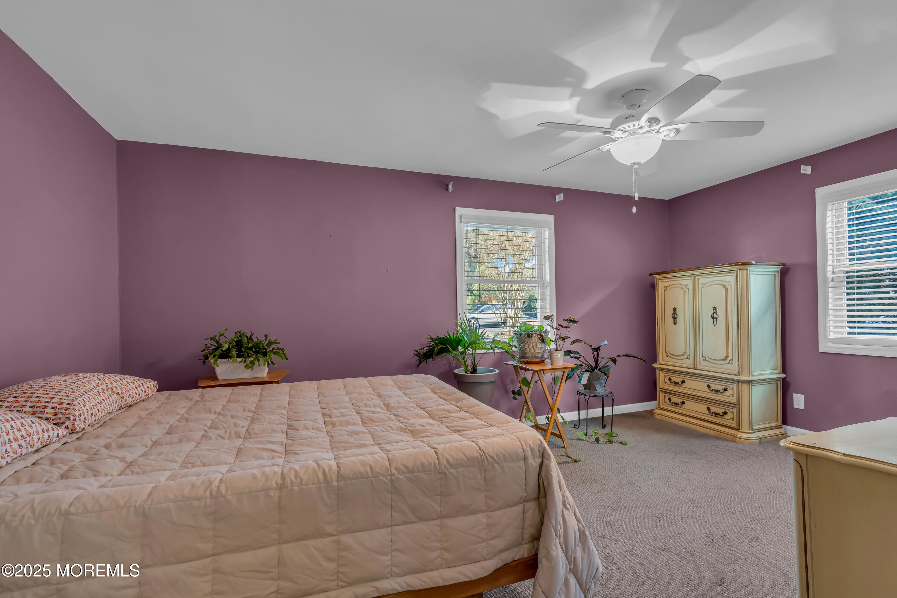 104 Garden Road Shrewsbury, NJ 07702 - Photo 13 of 24 a bedroom with a bed and a chandelier
