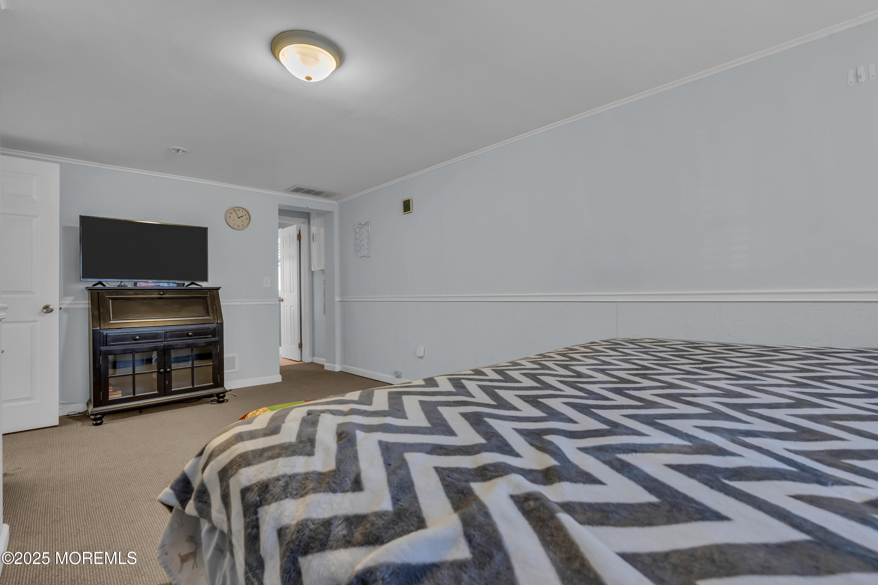 104 Garden Road Shrewsbury, NJ 07702 - Photo 18 of 24 a bedroom with a bed and a flat screen tv