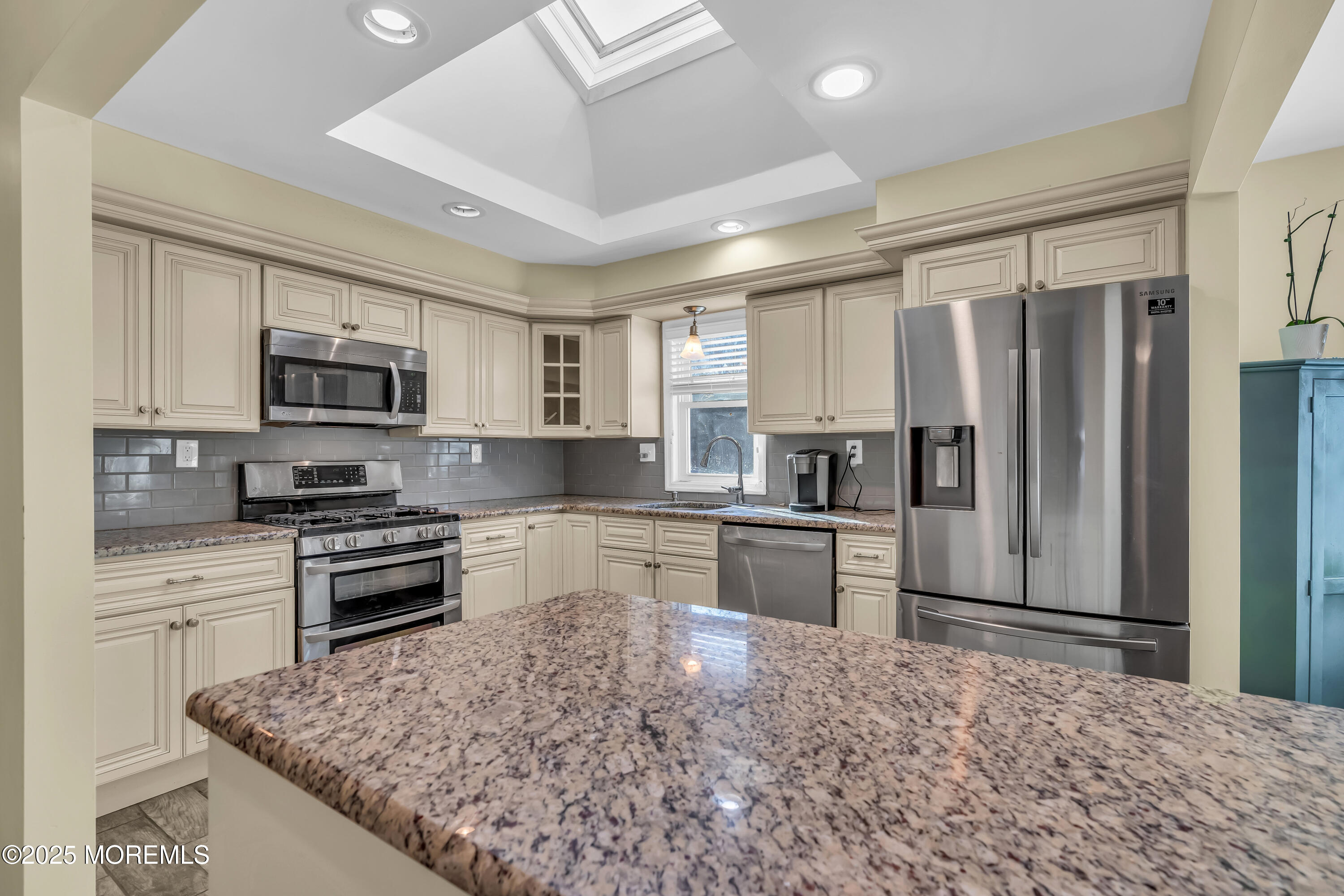 104 Garden Road Shrewsbury, NJ 07702 - Photo 3 of 24 a kitchen with granite countertop a refrigerator stove top oven and sink