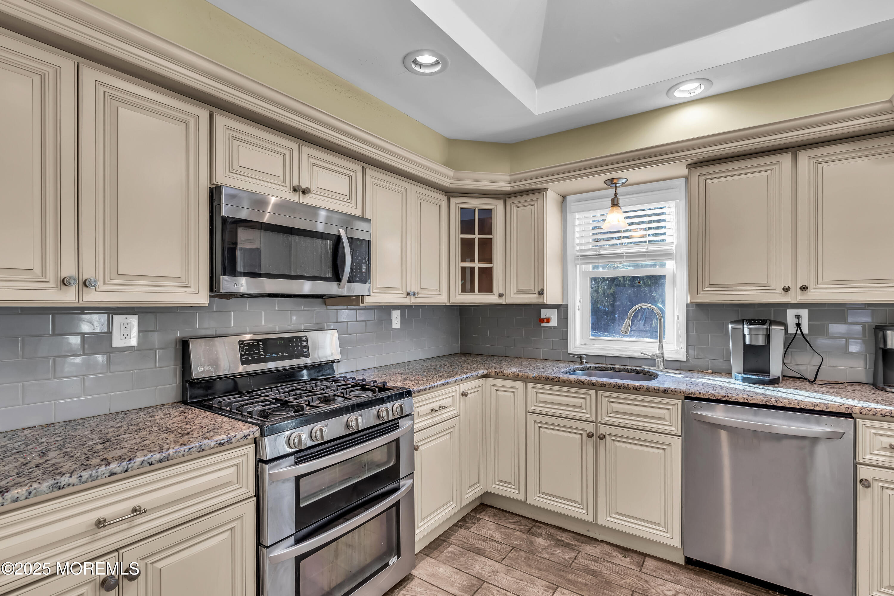 104 Garden Road Shrewsbury, NJ 07702 - Photo 4 of 24 a kitchen with granite countertop a sink stainless steel appliances and cabinets