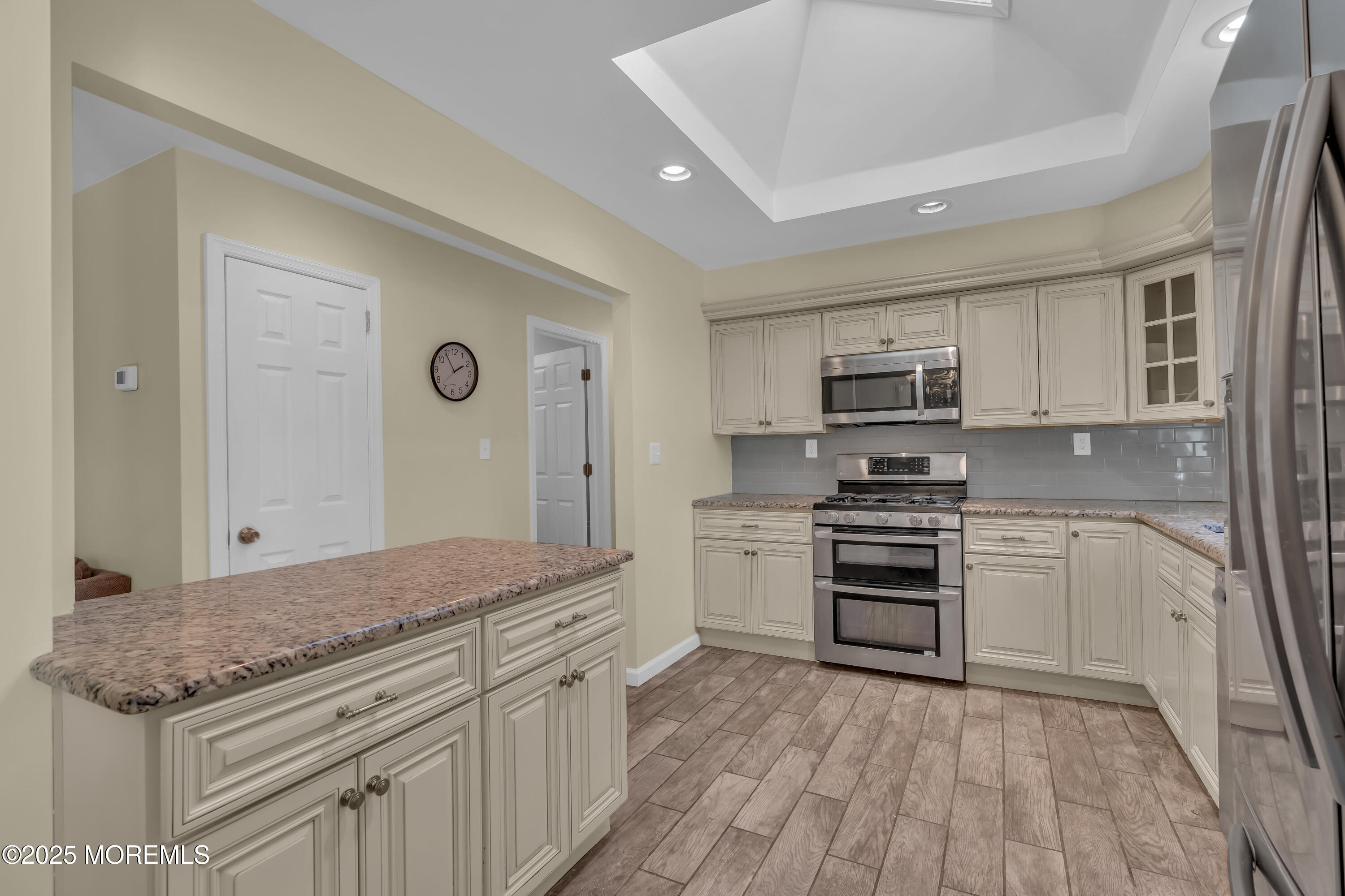 104 Garden Road Shrewsbury, NJ 07702 - Photo 5 of 24 a kitchen with stainless steel appliances granite countertop a stove top oven a sink and dishwasher a refrigerator with wooden floor