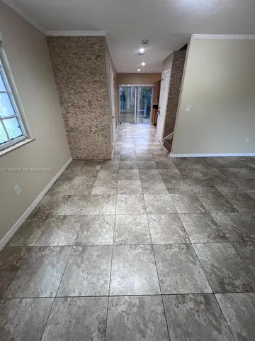 a view of an empty room and a windows