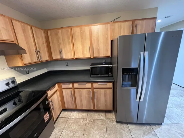 a kitchen with a sink a counter top space and a window