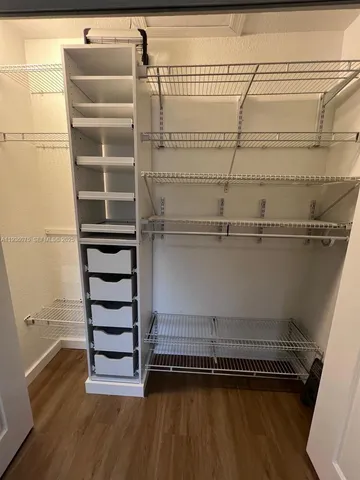 a bathroom with a granite countertop toilet sink and mirror