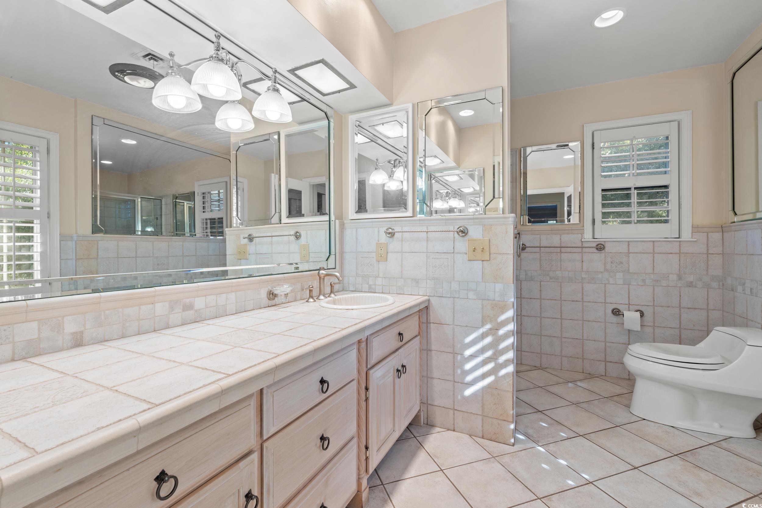 607 North Main Street Nichols, SC 29581 - Photo 16 of 39 Full bathroom featuring light tile patterned flooring, vanity, tile walls, and recessed lighting
