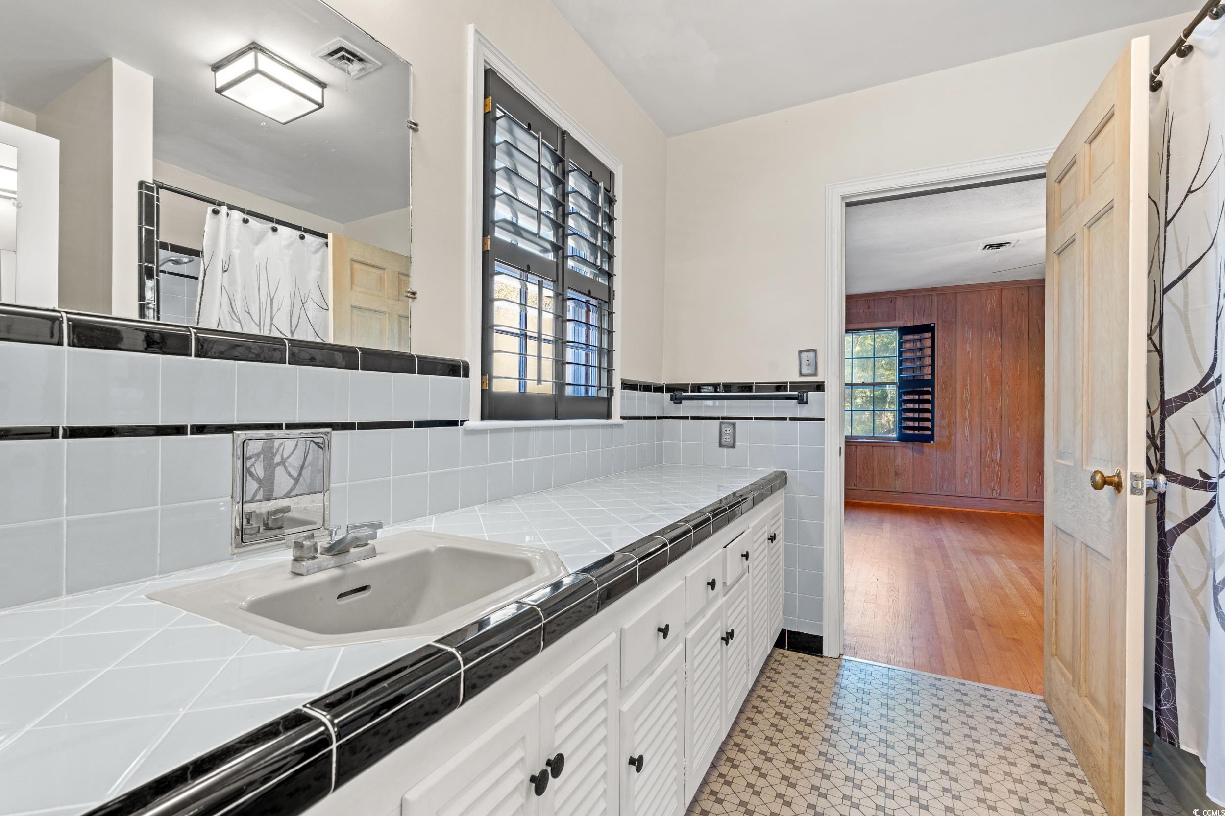 607 North Main Street Nichols, SC 29581 - Photo 19 of 39 Bathroom featuring a shower with curtain, vanity, and light flooring