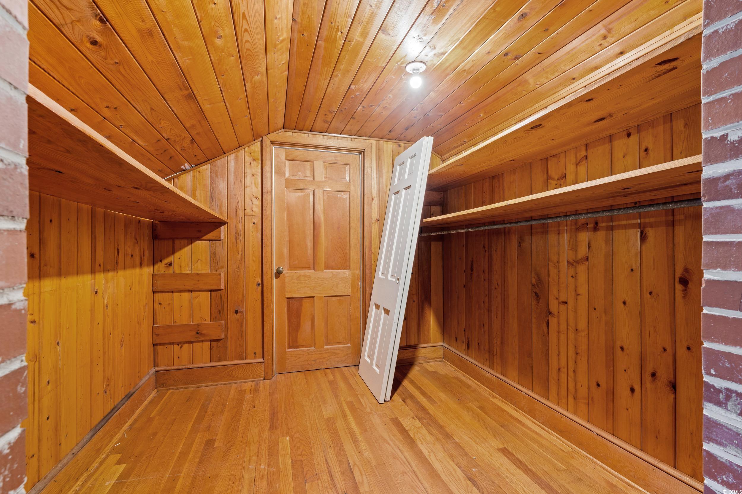 607 North Main Street Nichols, SC 29581 - Photo 21 of 39 Bonus room featuring light wood finished floors, vaulted ceiling, and wood walls