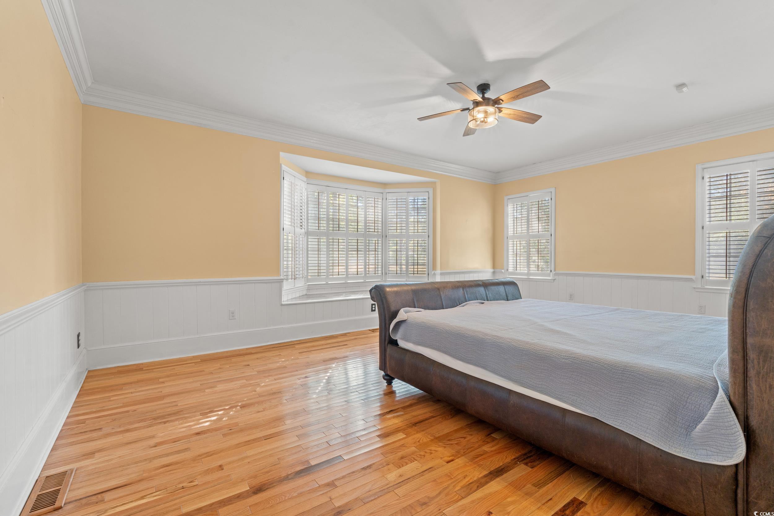 607 North Main Street Nichols, SC 29581 - Photo 24 of 39 Bedroom with light wood finished floors, ceiling fan, ornamental molding, and wainscoting