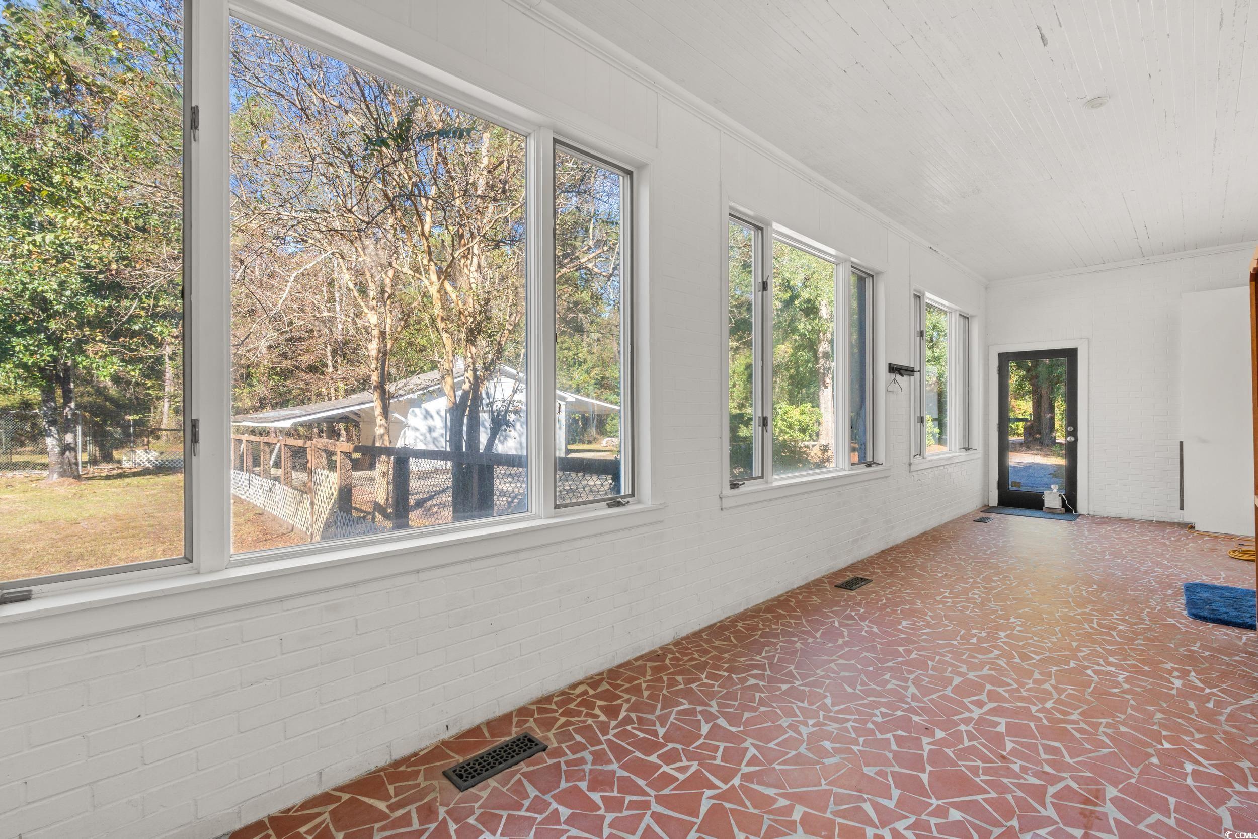 607 North Main Street Nichols, SC 29581 - Photo 26 of 39 Unfurnished sunroom featuring ornamental molding and brick wall