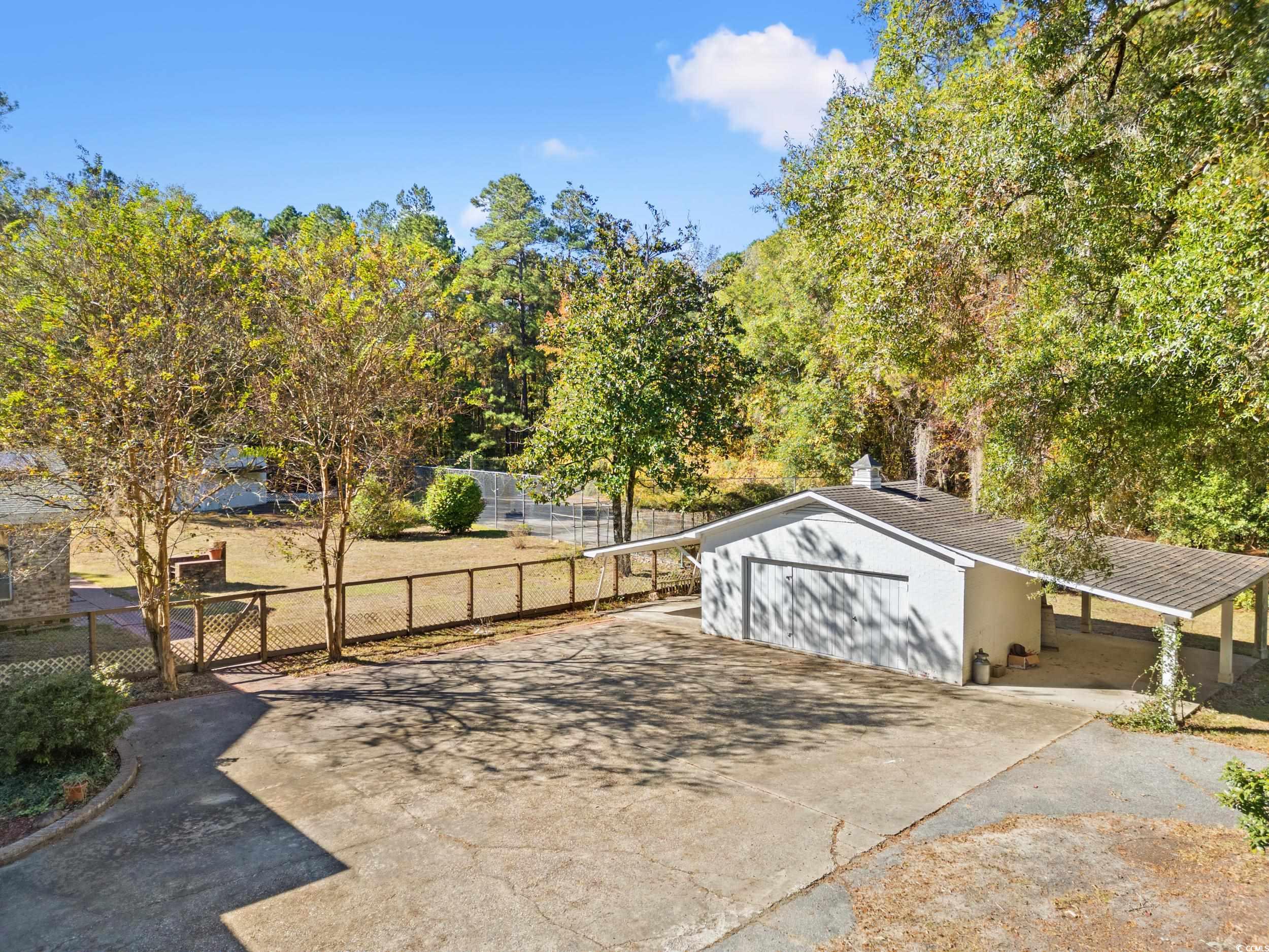 607 North Main Street Nichols, SC 29581 - Photo 35 of 39 View of patio with concrete driveway and a garage