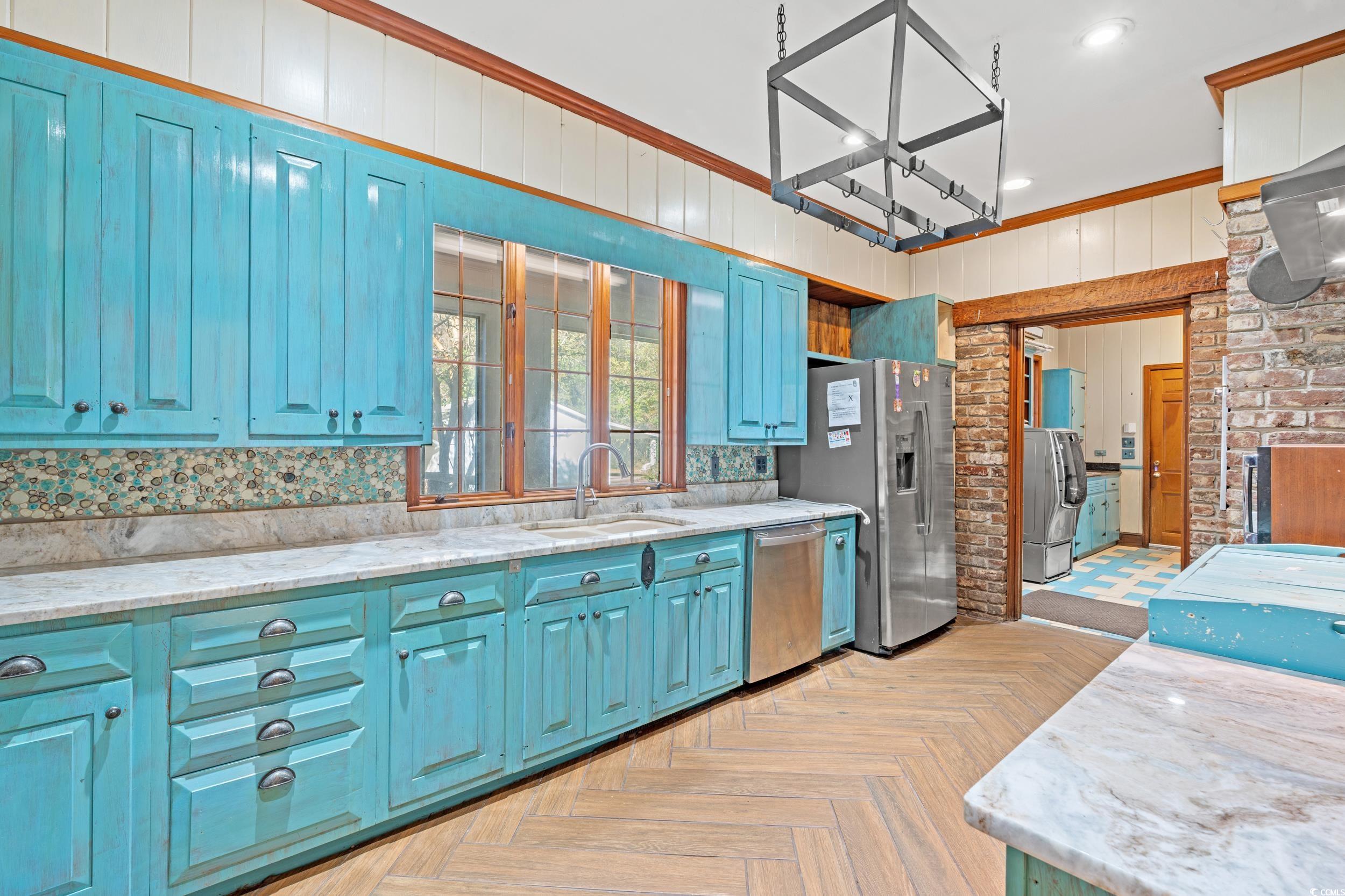 607 North Main Street Nichols, SC 29581 - Photo 9 of 39 Kitchen featuring blue cabinets, crown molding, appliances with stainless steel finishes, light stone counters, and recessed lighting