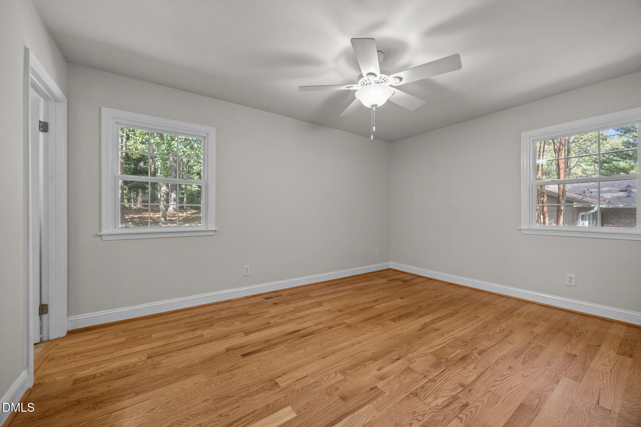 704 Brighton Road Durham, NC 27707 - Photo 13 of 23 a view of an empty room with wooden floor and a window