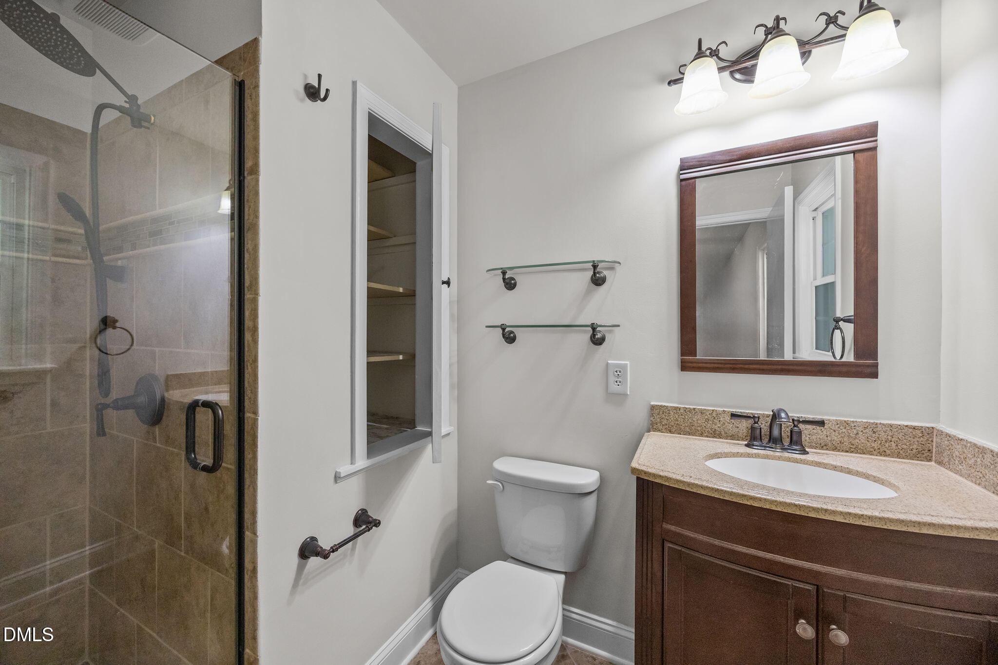 704 Brighton Road Durham, NC 27707 - Photo 18 of 25 a bathroom with a granite countertop sink toilet and shower