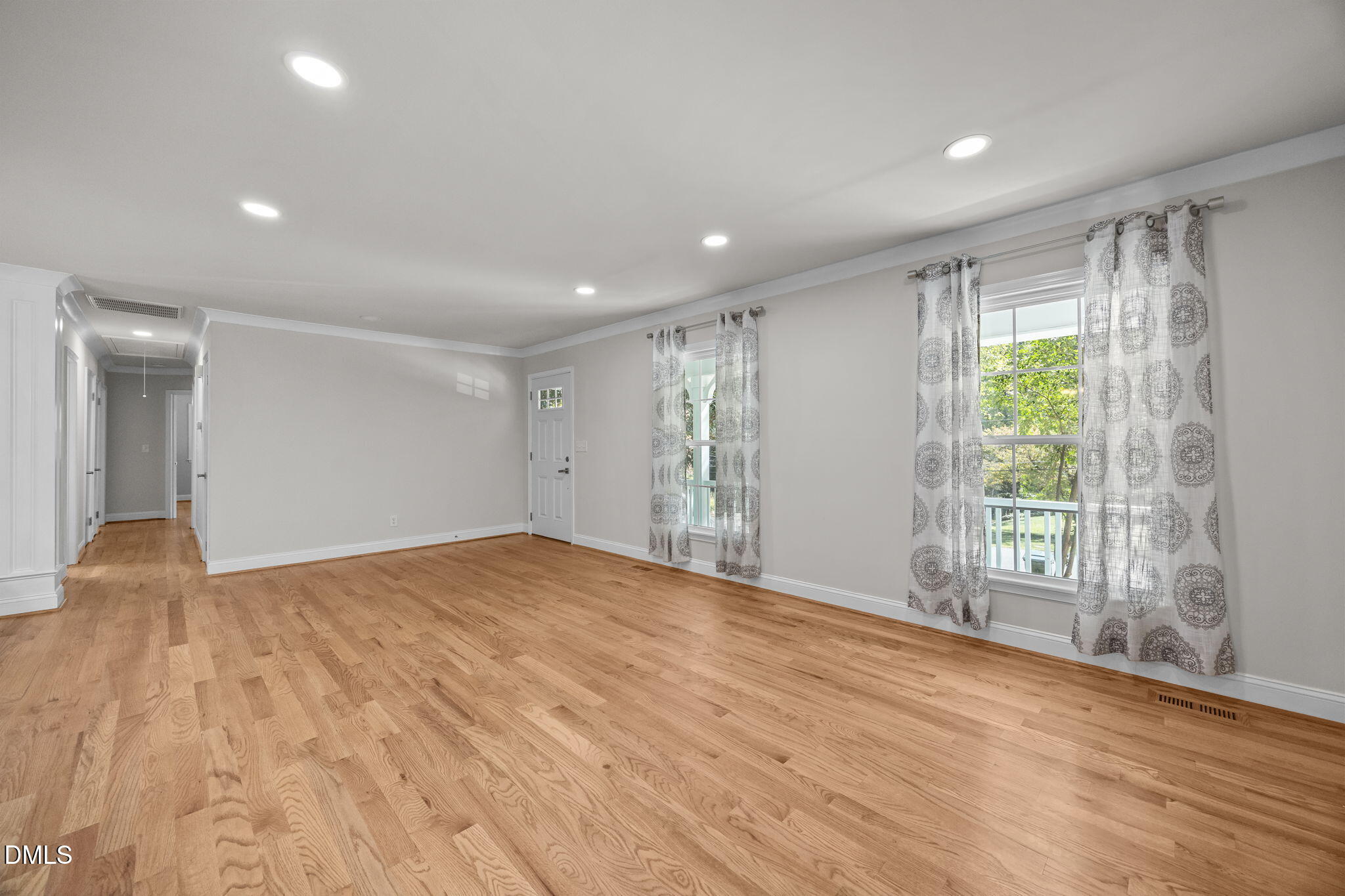 704 Brighton Road Durham, NC 27707 - Photo 6 of 25 a view of an empty room with wooden floor and a window