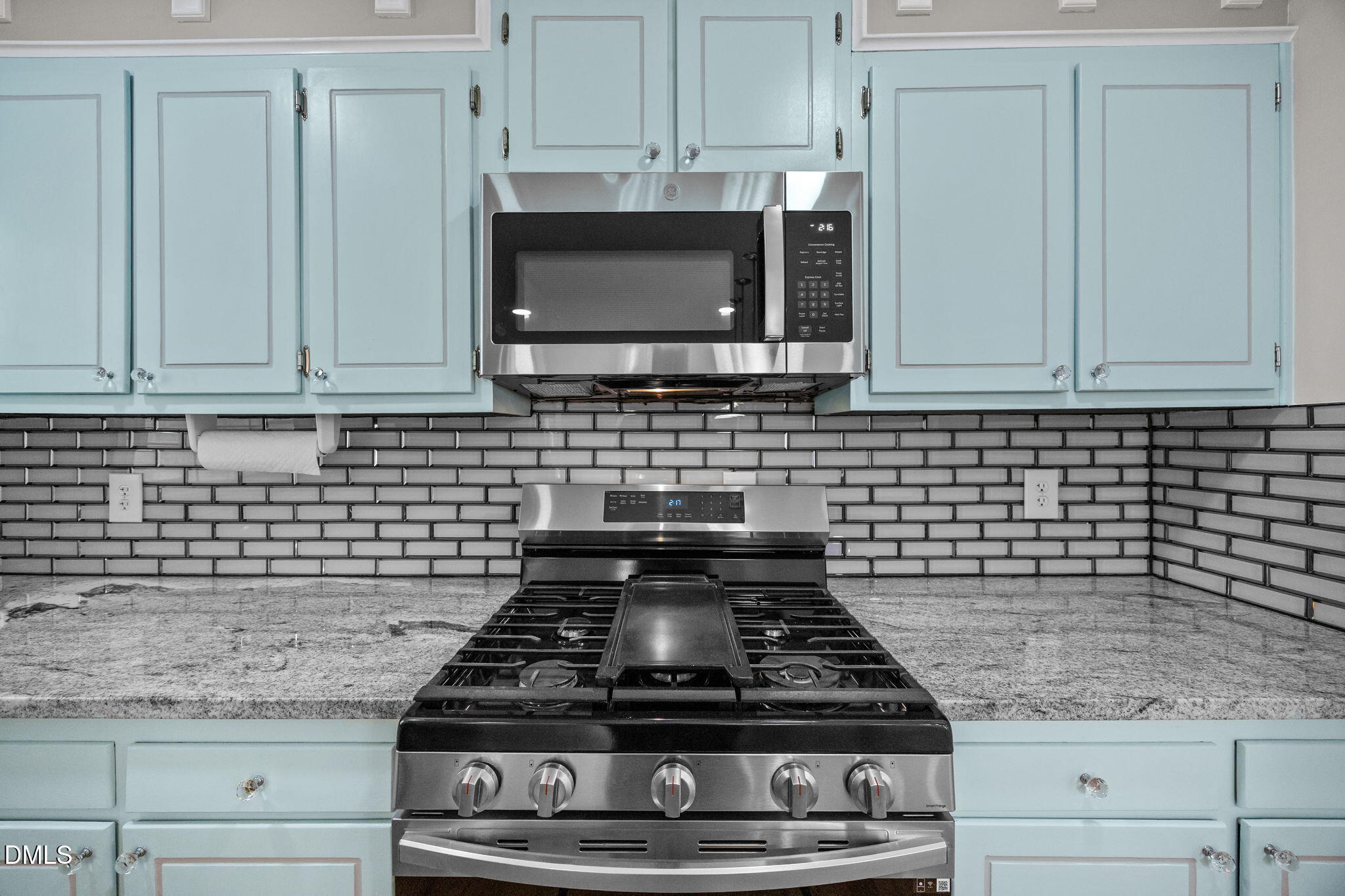 704 Brighton Road Durham, NC 27707 - Photo 7 of 23 a kitchen with granite countertop a stove and a sink