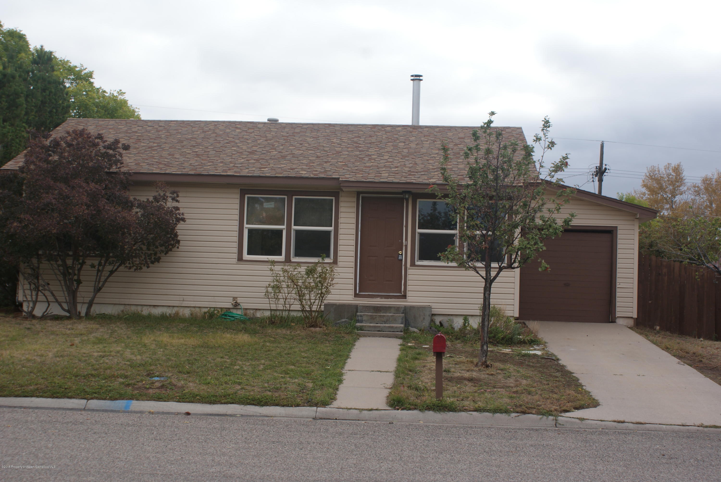 322 Elm Avenue Rifle, CO 81650 - Photo 1 of 13 a front view of a house with a yard