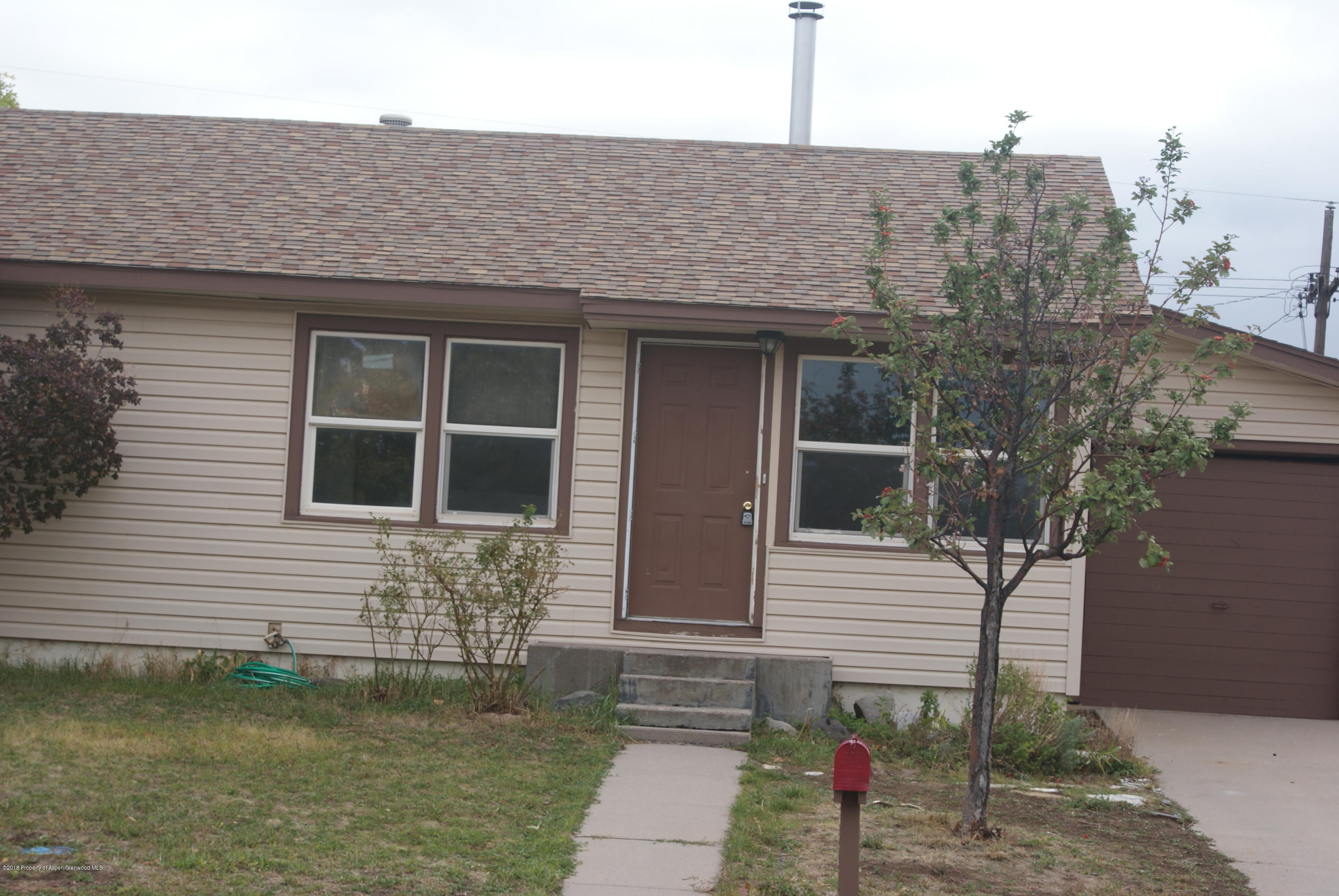 322 Elm Avenue Rifle, CO 81650 - Photo 2 of 13 a front view of a house with a yard