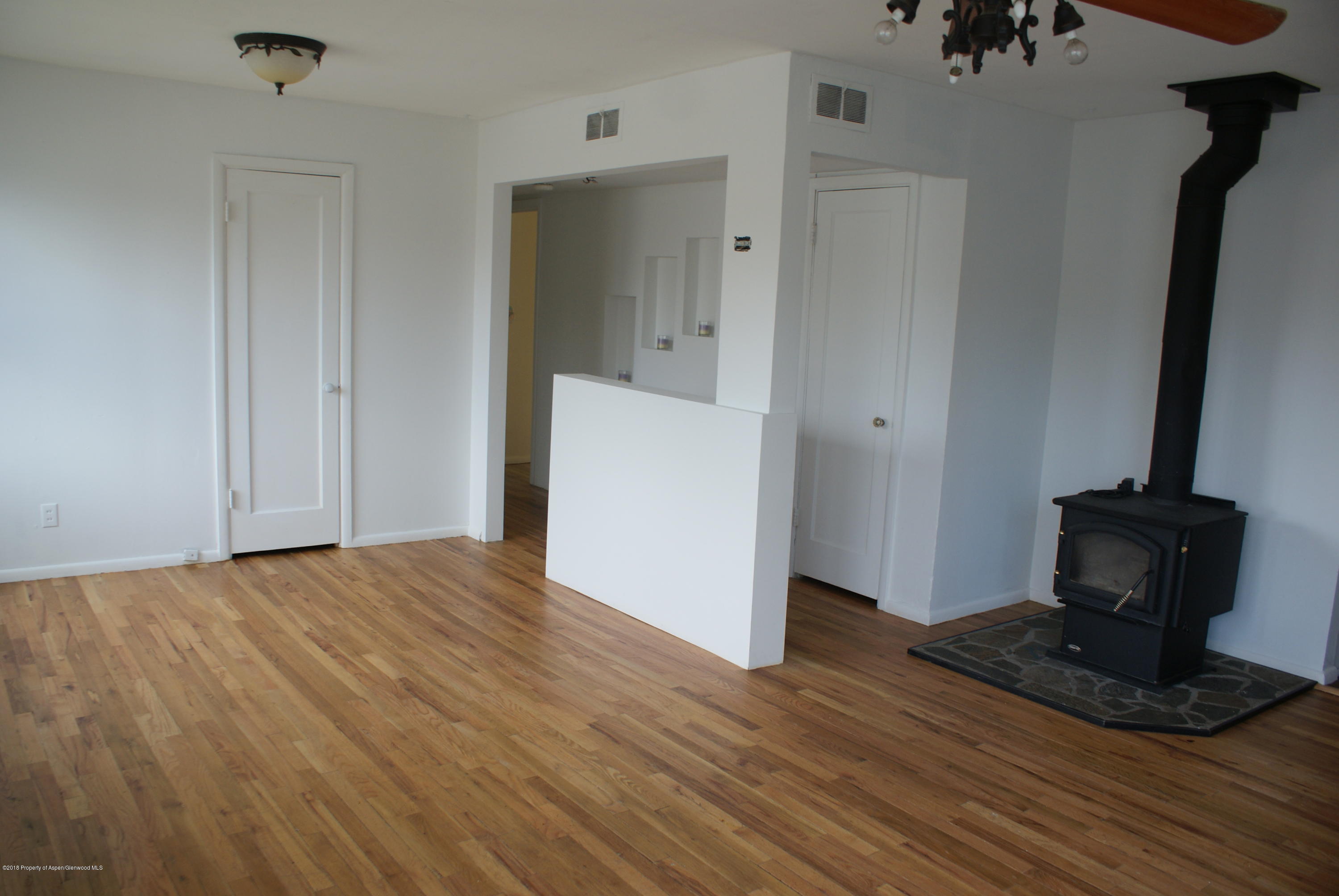 322 Elm Avenue Rifle, CO 81650 - Photo 3 of 13 a view of empty room with wooden floor