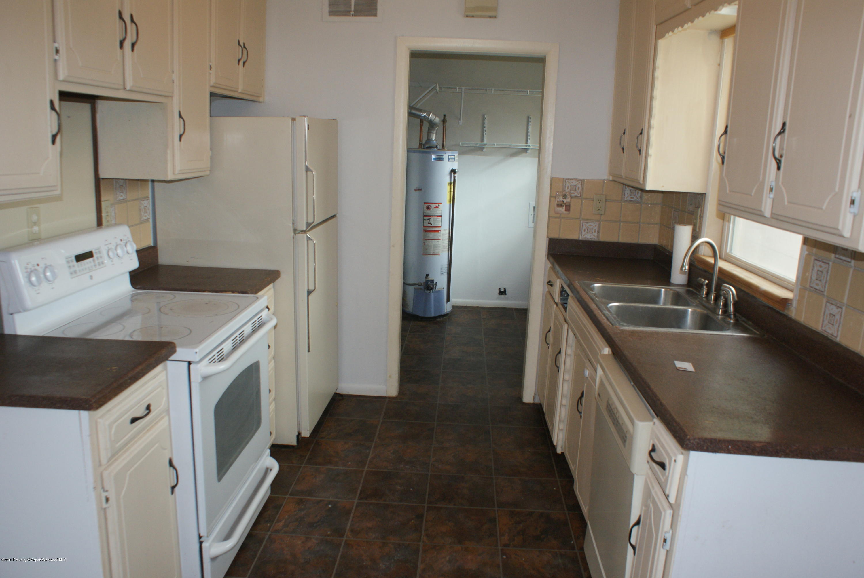 322 Elm Avenue Rifle, CO 81650 - Photo 5 of 13 a kitchen with a sink stove and refrigerator