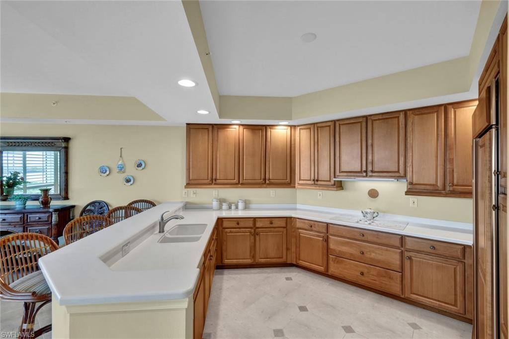 295 Grande Way, Unit 405 Naples, FL 34110 - Photo 13 of 40 a kitchen with a sink and cabinets