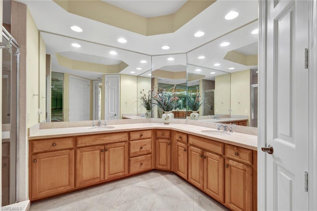 295 Grande Way, Unit 405 Naples, FL 34110 - Photo 18 of 40 a large kitchen with a sink and cabinets