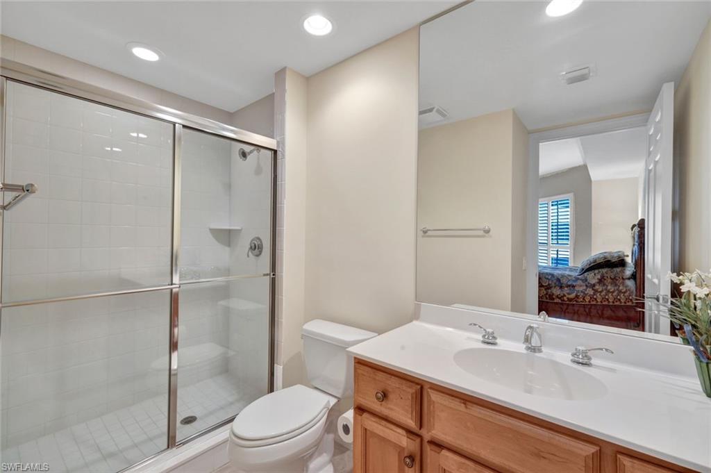 295 Grande Way, Unit 405 Naples, FL 34110 - Photo 20 of 40 a bathroom with a sink toilet and shower