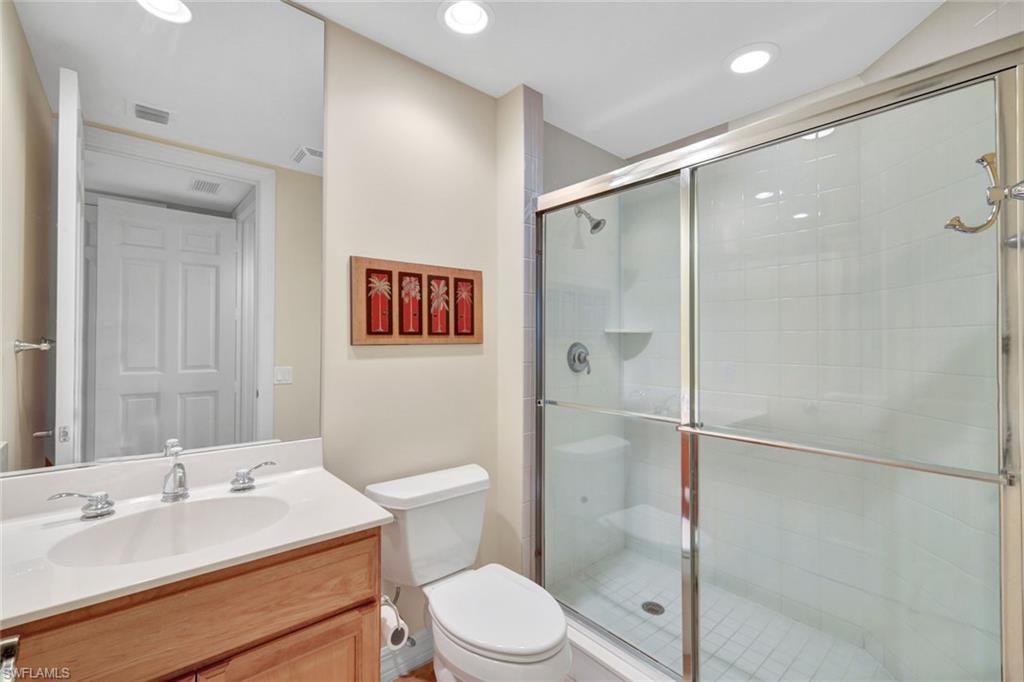 295 Grande Way, Unit 405 Naples, FL 34110 - Photo 22 of 40 a bathroom with a sink toilet and shower
