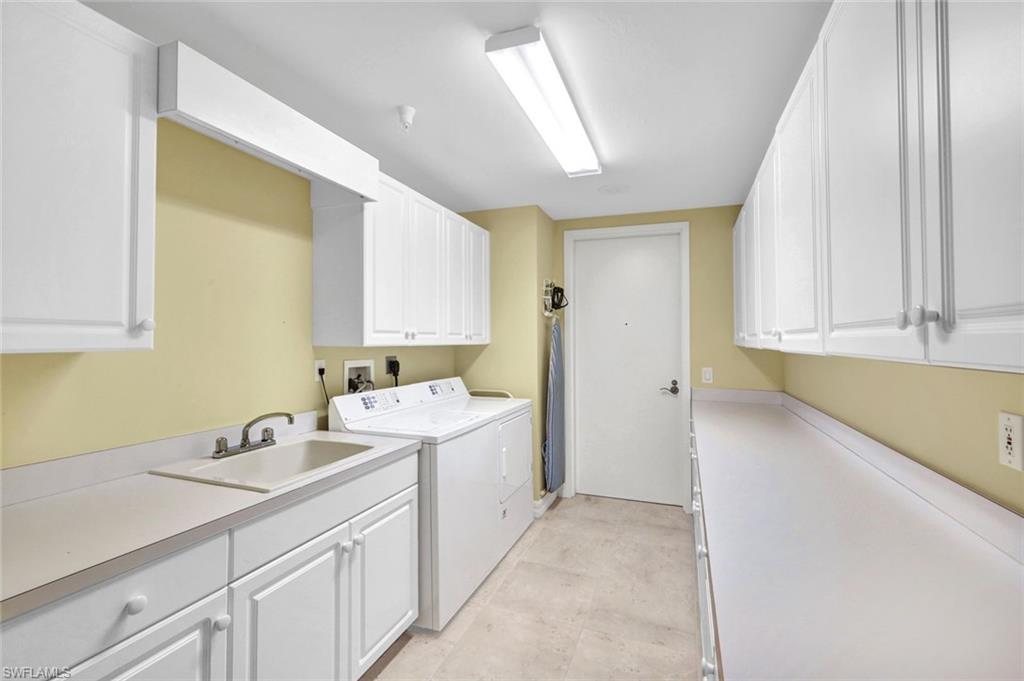 295 Grande Way, Unit 405 Naples, FL 34110 - Photo 24 of 40 a room with a sink and cabinets