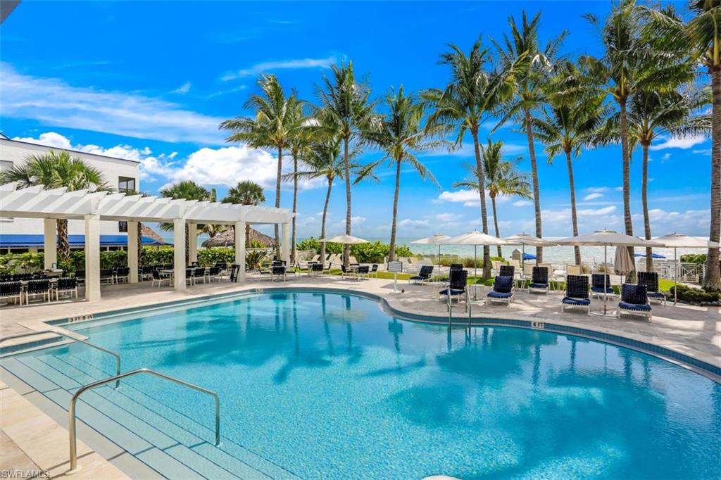 295 Grande Way, Unit 405 Naples, FL 34110 - Photo 39 of 40 a view of a swimming pool with chairs