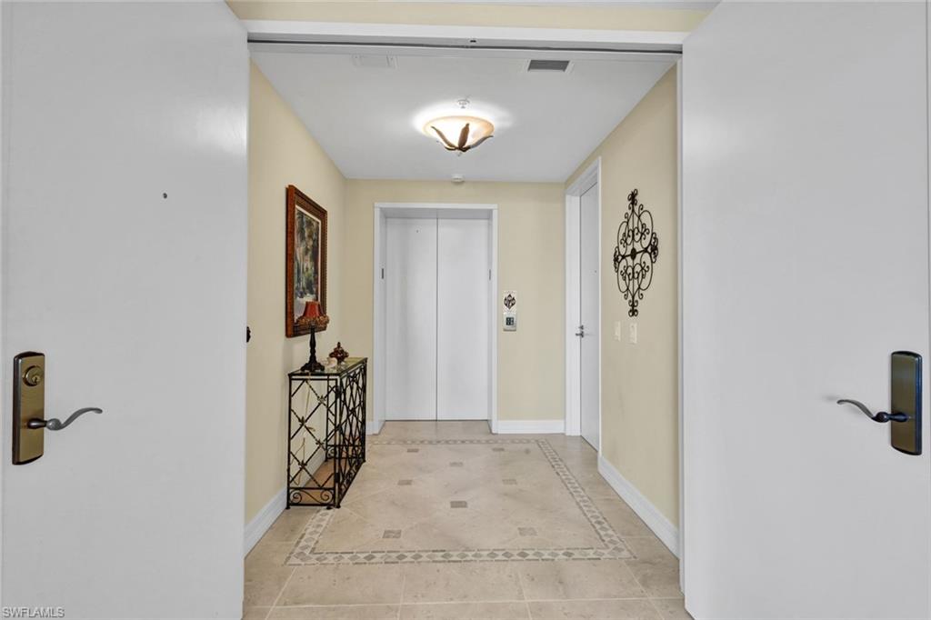 295 Grande Way, Unit 405 Naples, FL 34110 - Photo 4 of 40 a view of a hallway with closet and a window