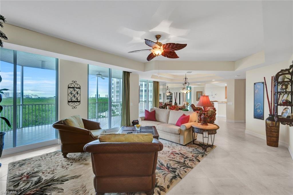 295 Grande Way, Unit 405 Naples, FL 34110 - Photo 5 of 40 a living room with furniture ceiling fan and a window