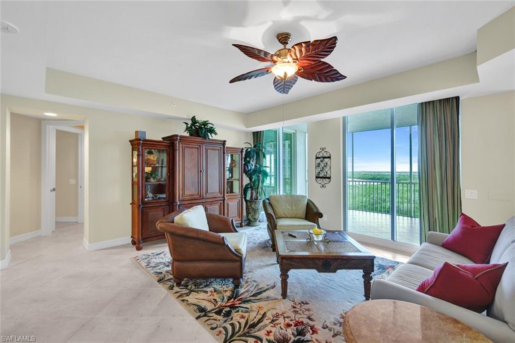 295 Grande Way, Unit 405 Naples, FL 34110 - Photo 7 of 40 a living room with furniture and a large window