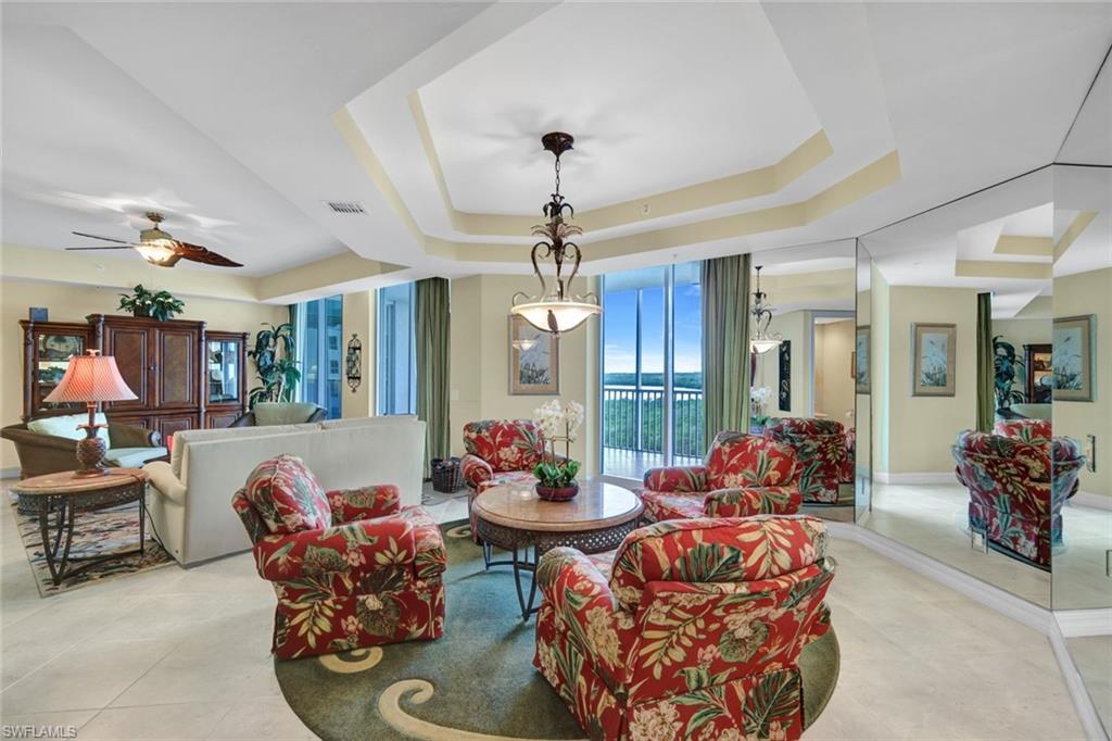 295 Grande Way, Unit 405 Naples, FL 34110 - Photo 9 of 40 a living room with furniture and a large window