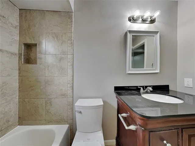 a view of a swimming pool with a patio and a backyard