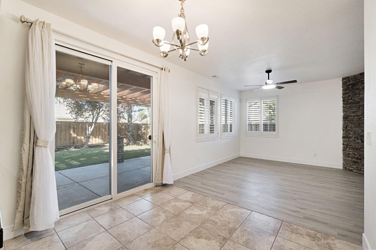 692 Blueberry Lane Madera, CA 93638 - Photo 11 of 44 a view of an empty room with glass door