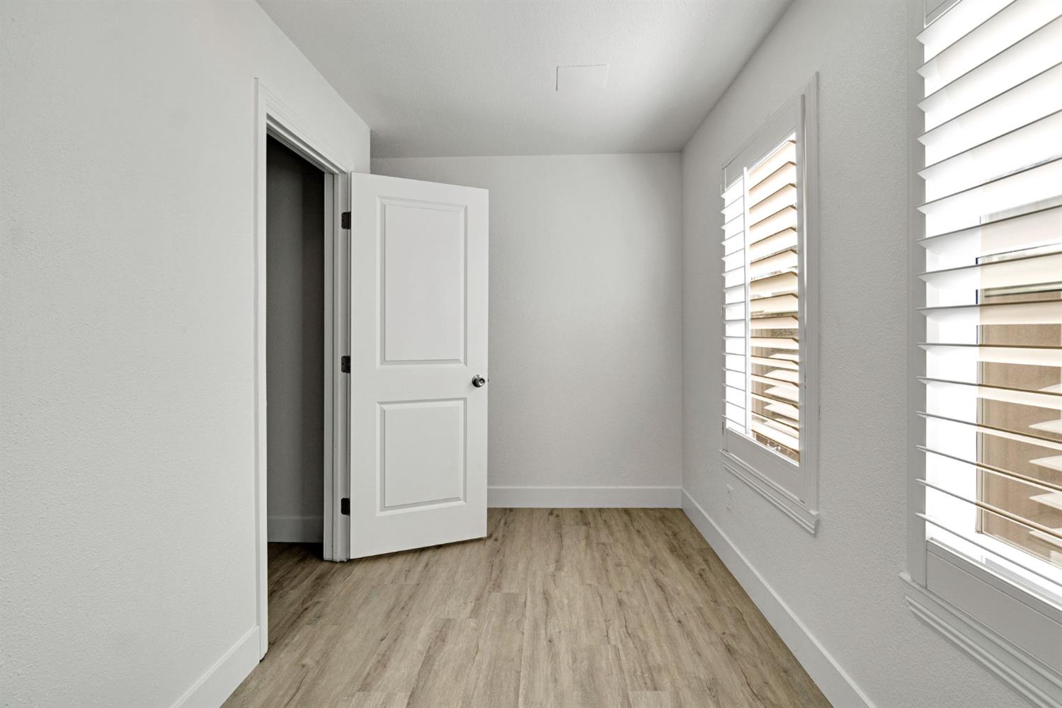 692 Blueberry Lane Madera, CA 93638 - Photo 26 of 44 a view of an empty room with wooden floor and a window