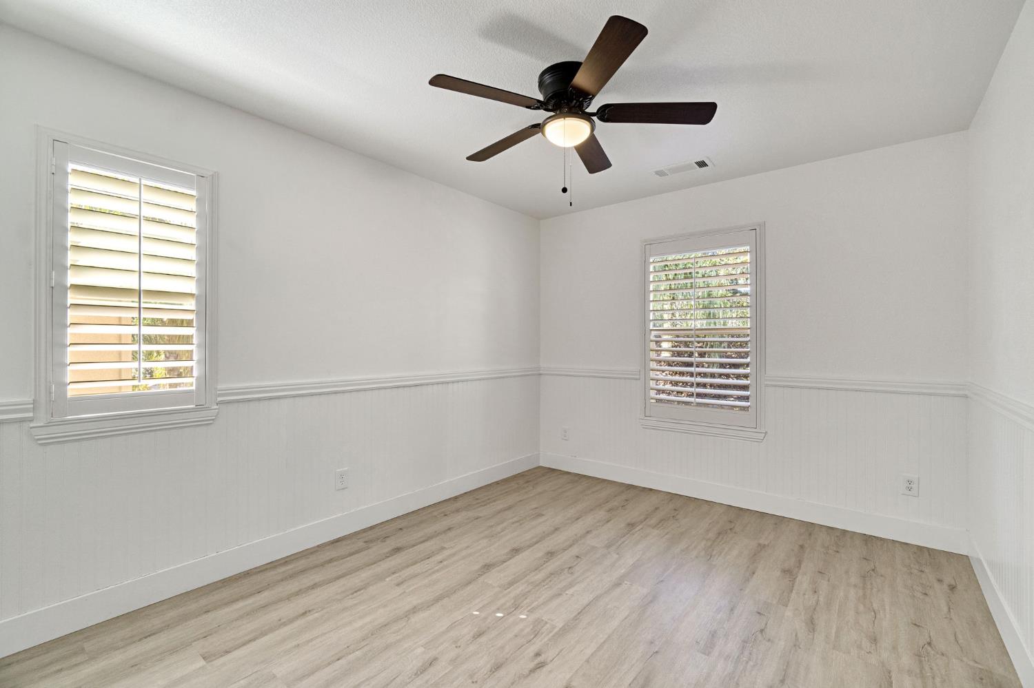 692 Blueberry Lane Madera, CA 93638 - Photo 27 of 44 a view of empty room with wooden floor and fan