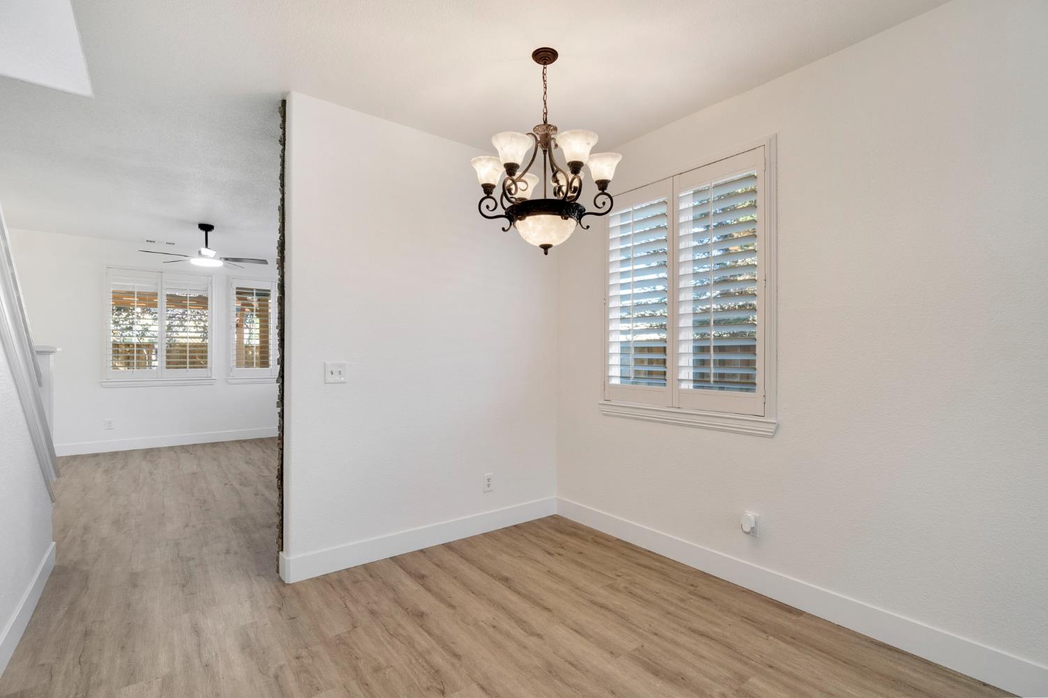 692 Blueberry Lane Madera, CA 93638 - Photo 6 of 44 a view of a room with wooden floor chandelier and windows